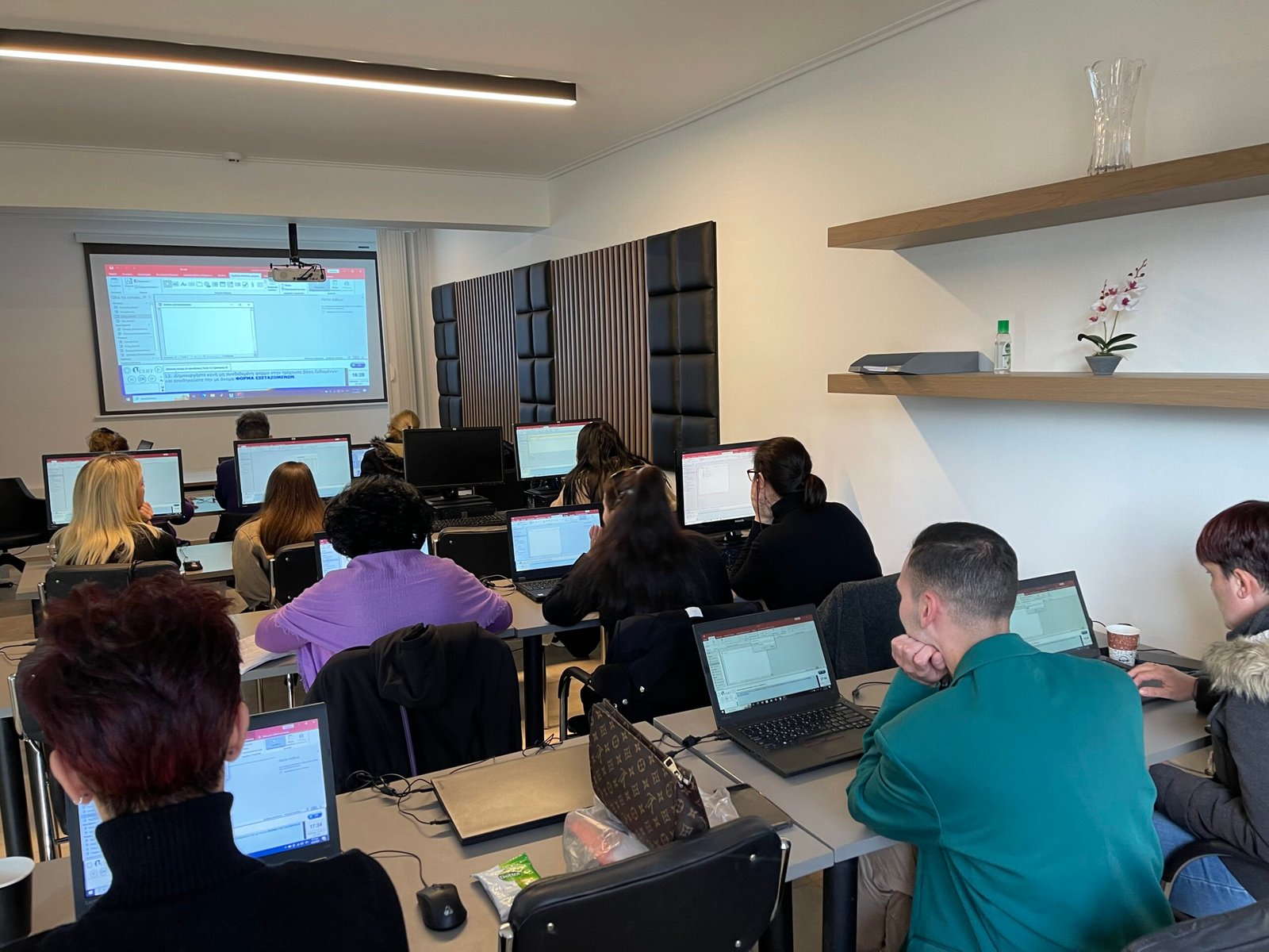 Students in a classroom learning how to use computers